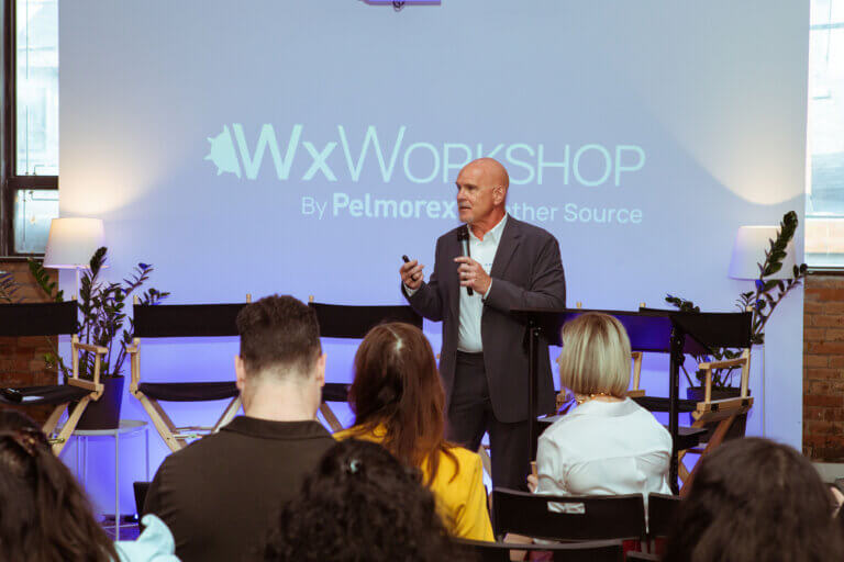 Speaker presenting at Wx Workshop event with audience.